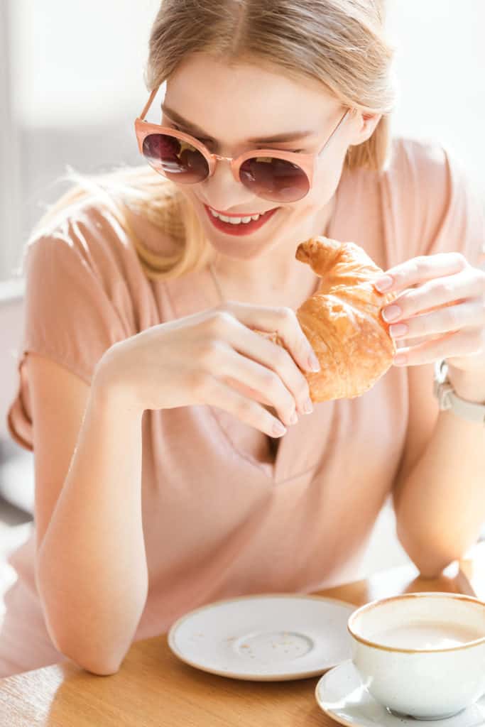 woman eating a crossaint