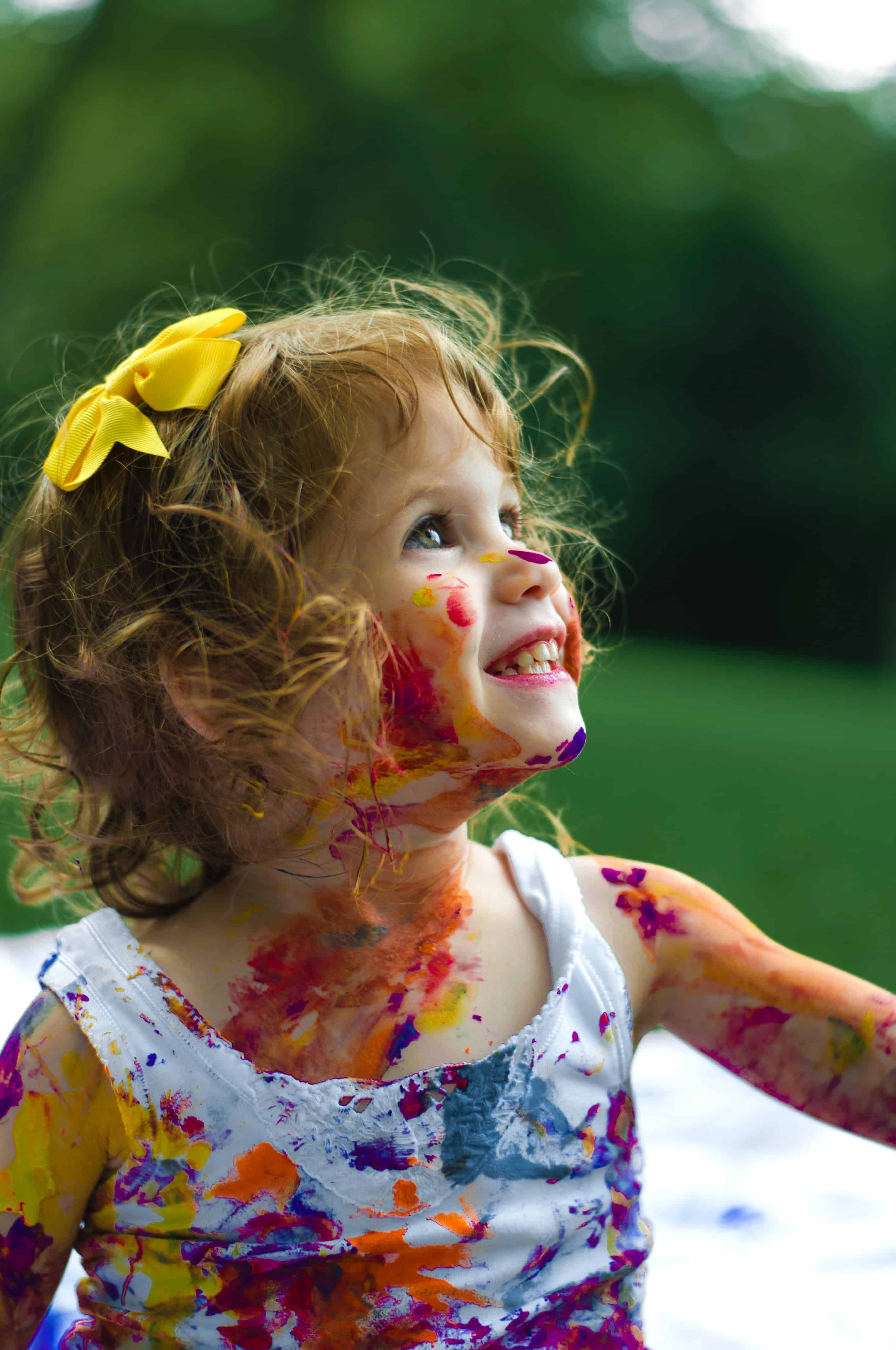 little girl with paint on her face.